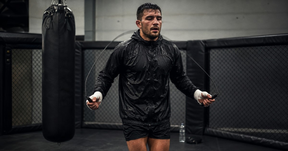 Realistic combat sports medical scene showing an athlete, scale, hydration check, and sports medicine support.